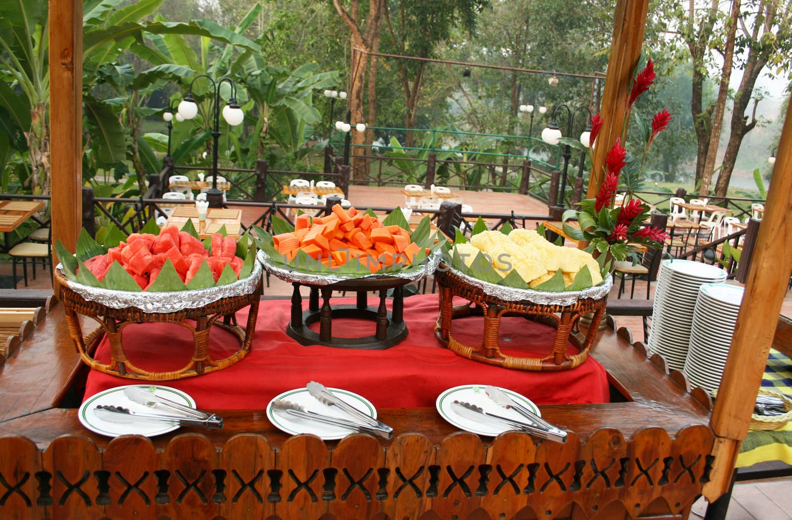 Wooden table with fruit, papaya, watermelon and pineapple