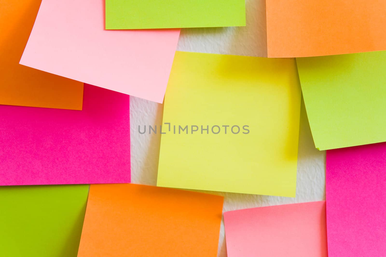 Blank sticky notes attached to a white wall.