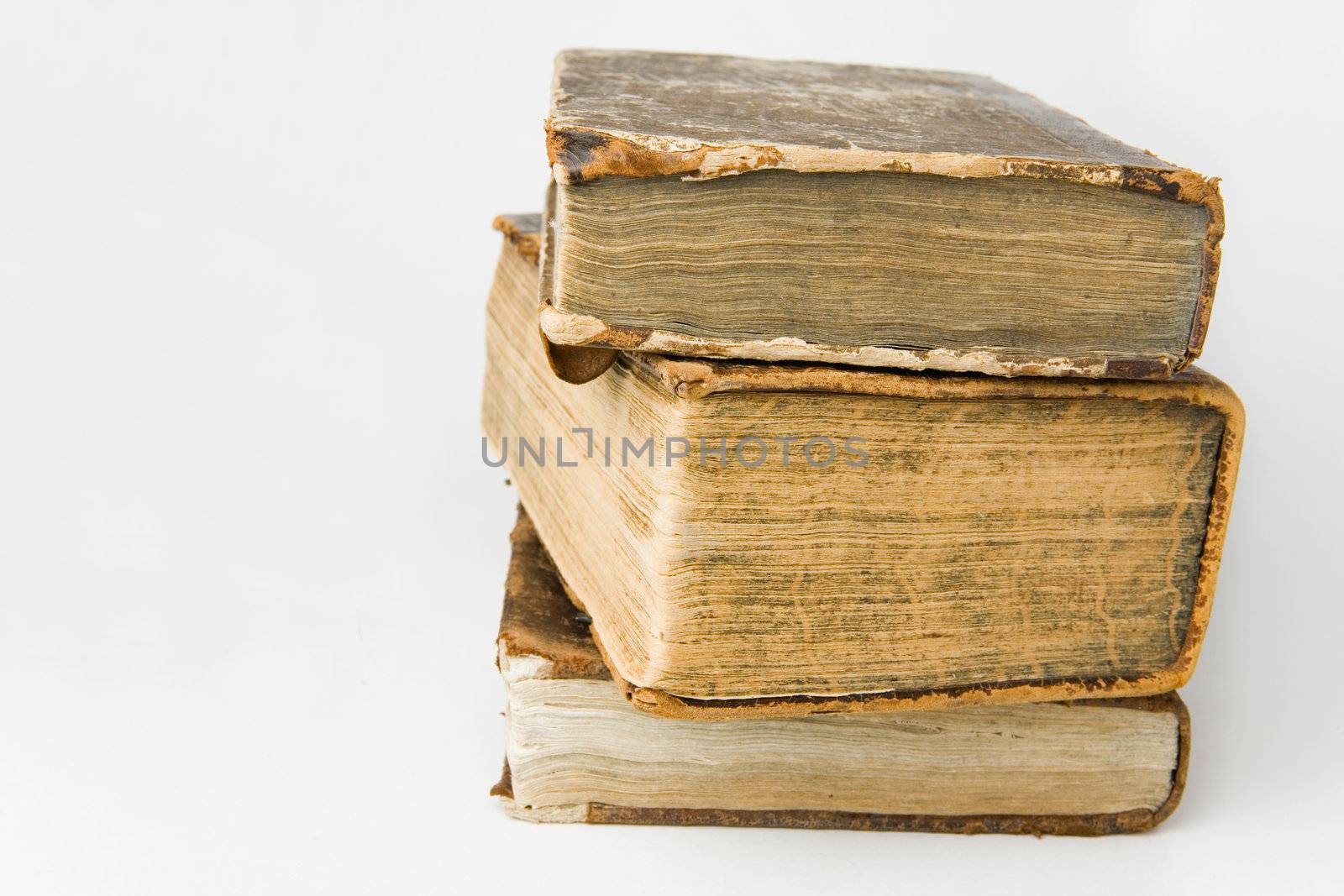 Antique books piled on a white background