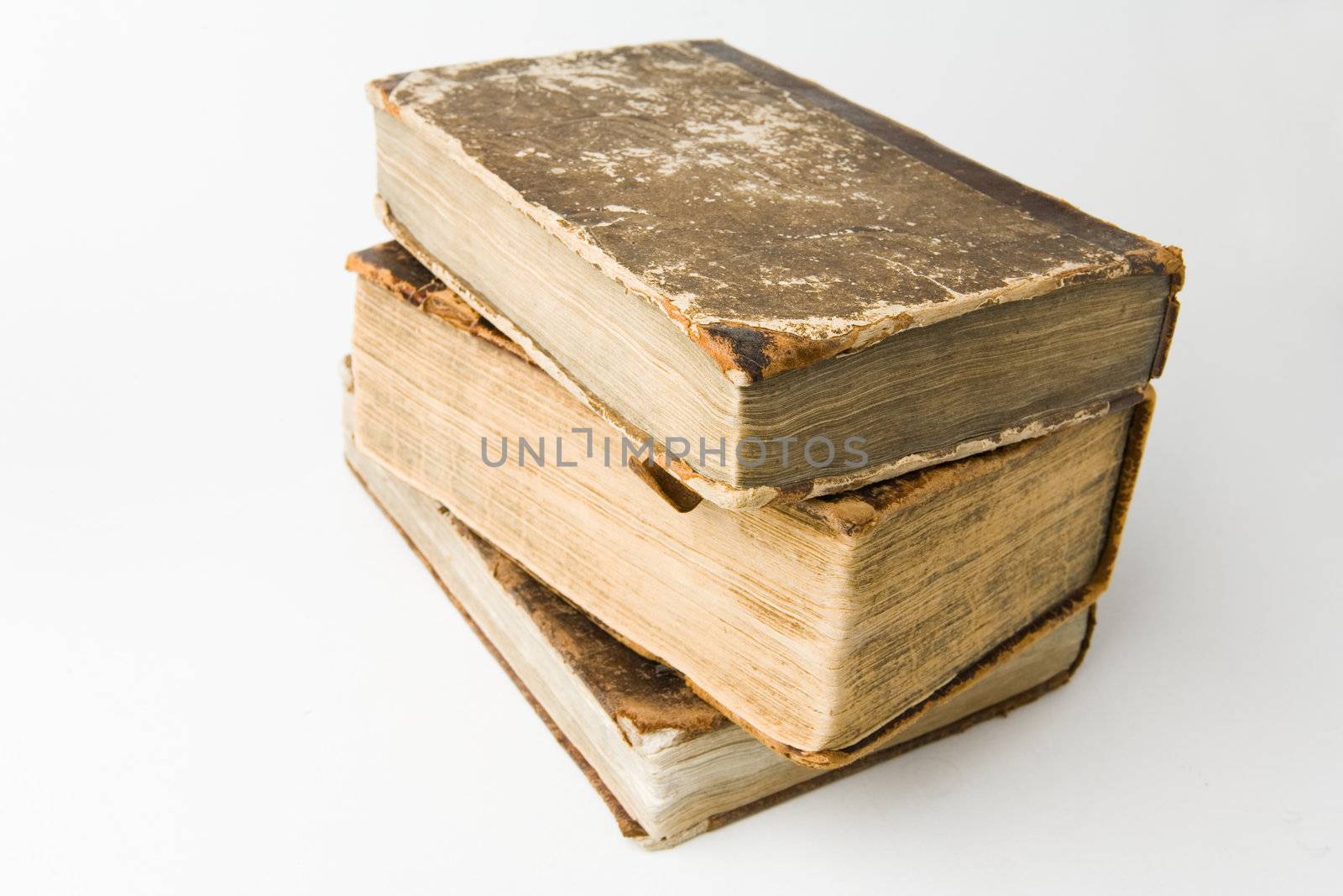 Antique books piled on a white background
