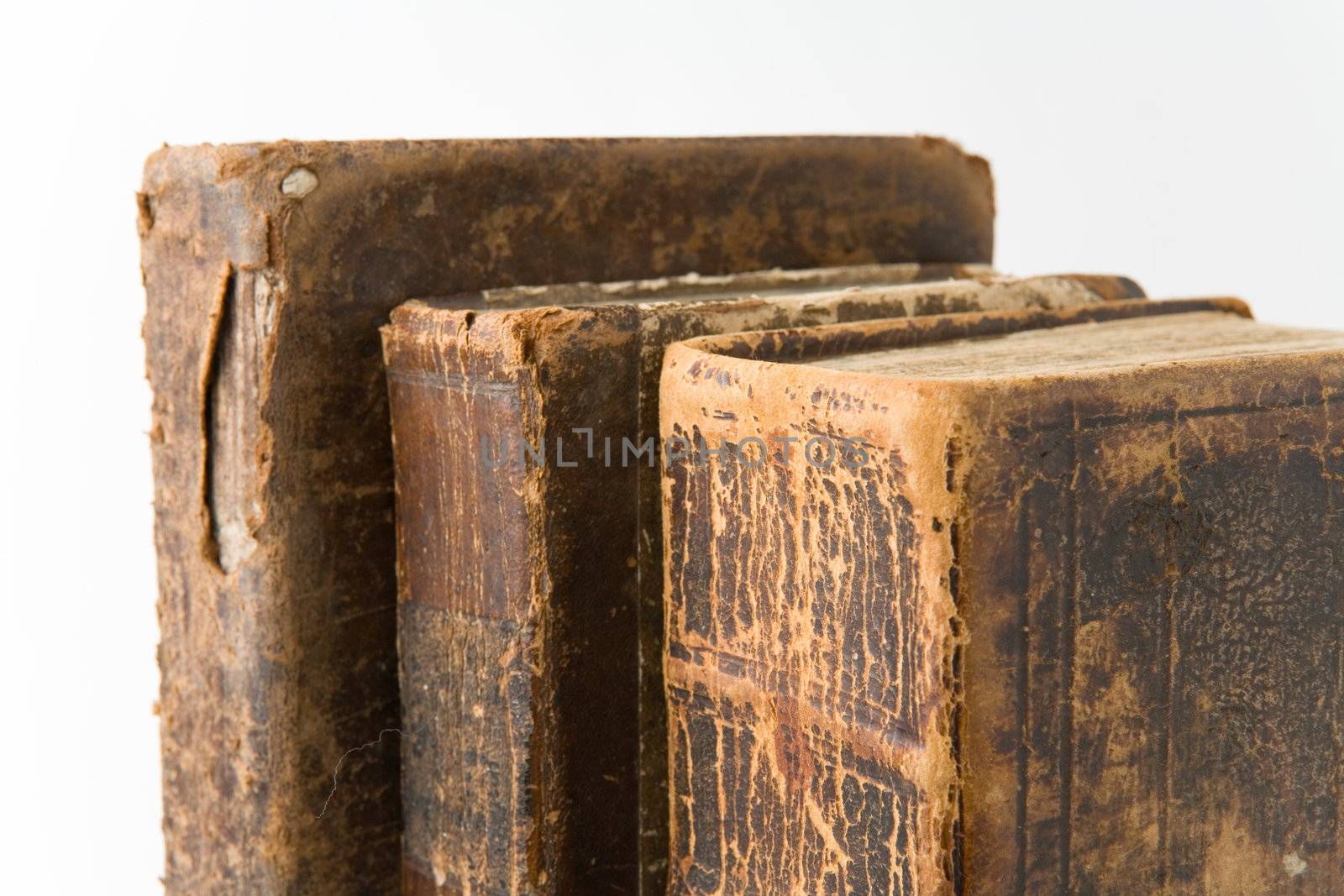 Row of antique books on a white background