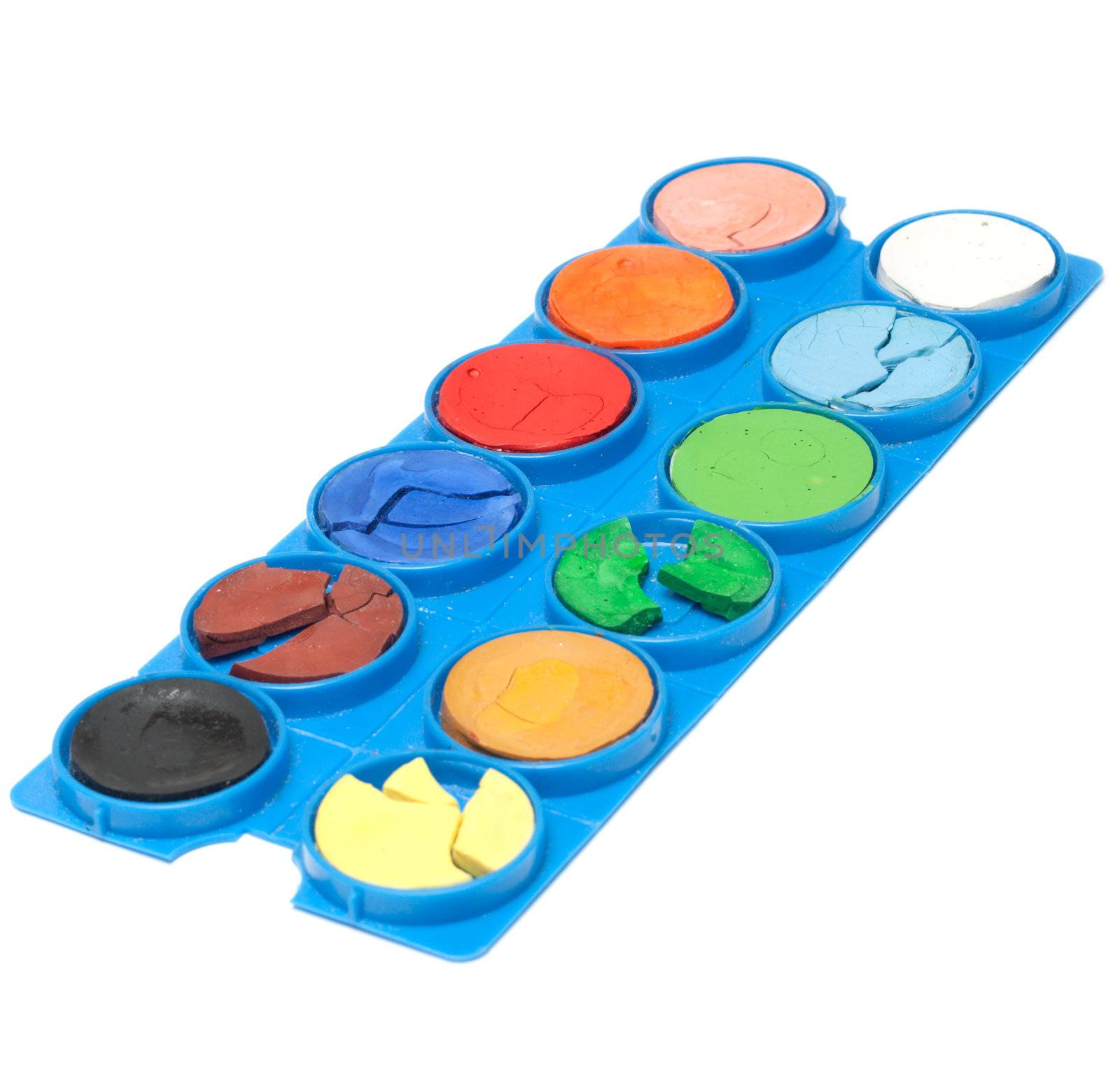 Aging plastic palette with watercolor paint on white background