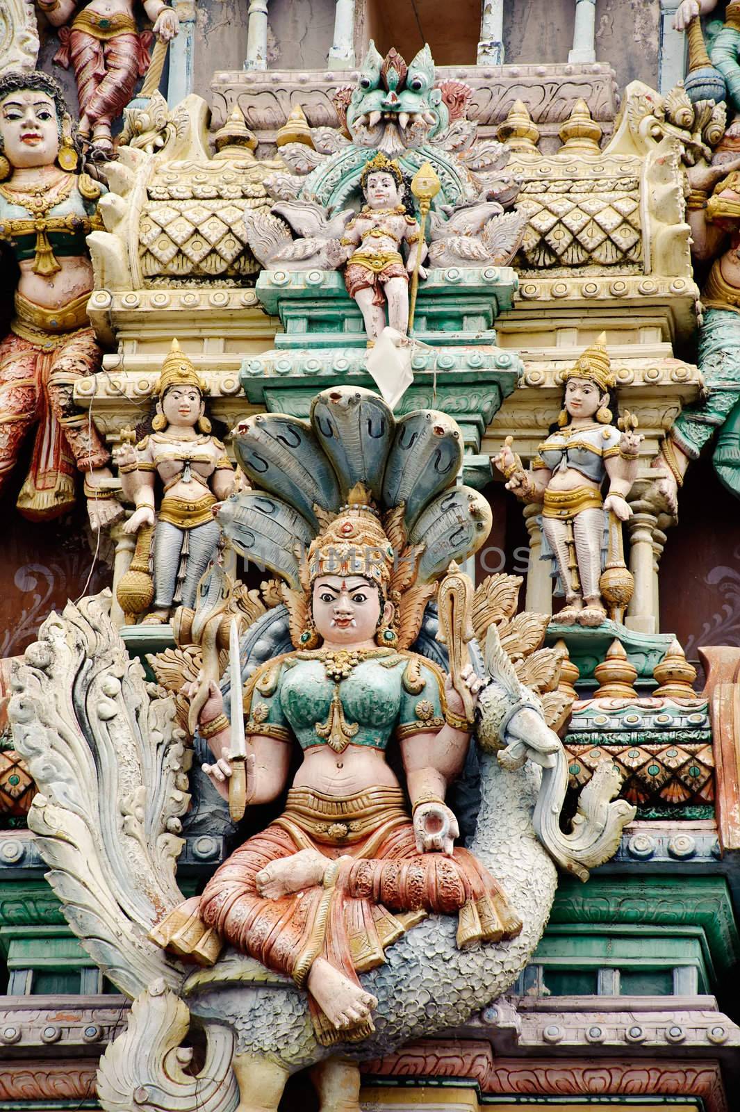 Hindu temple with statues of India god in roof.