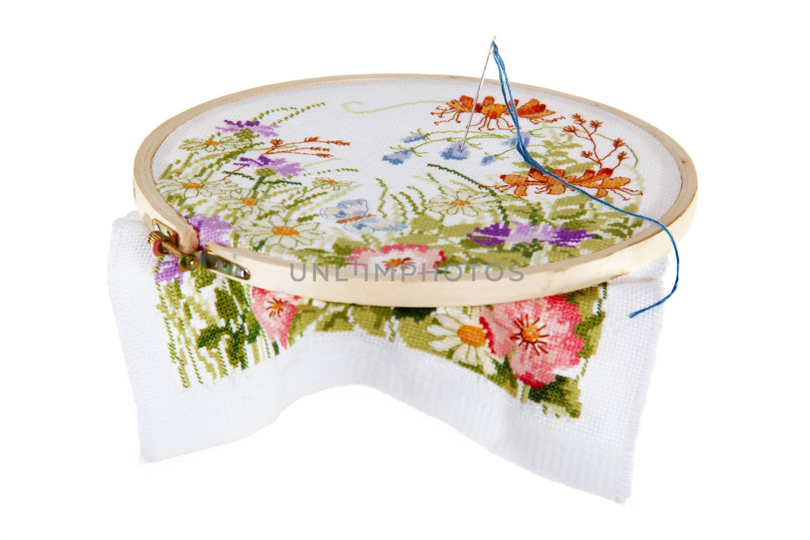 Handwork on embroidery of a picture with the image of colours, with application of colour threads from silk, on a white background.