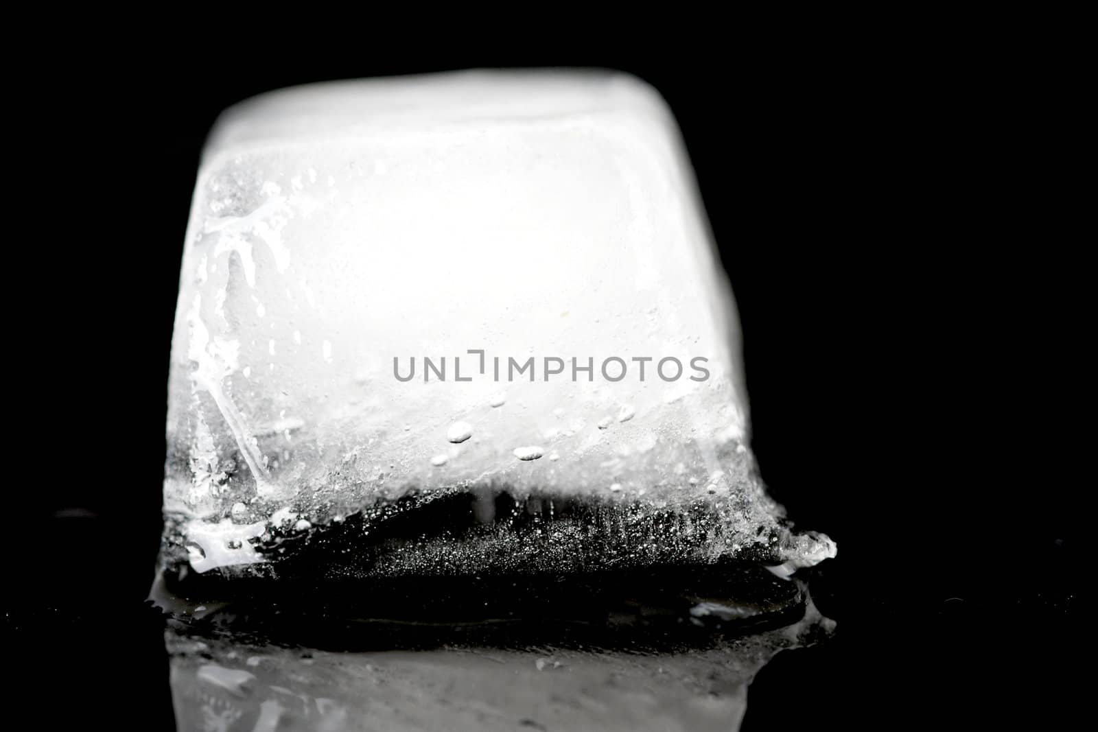 an closeup of an icecub on a black background