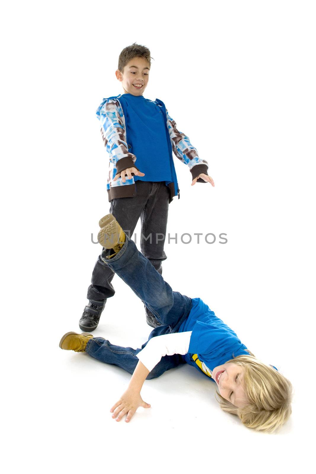 The big brother is throwing his little brother on the ground