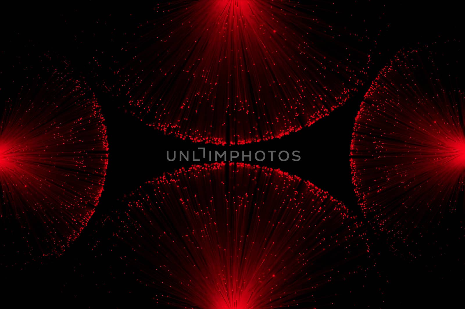 Four groups of illuminated red fibre optic light strands eminating from each edge of the image against a black background.