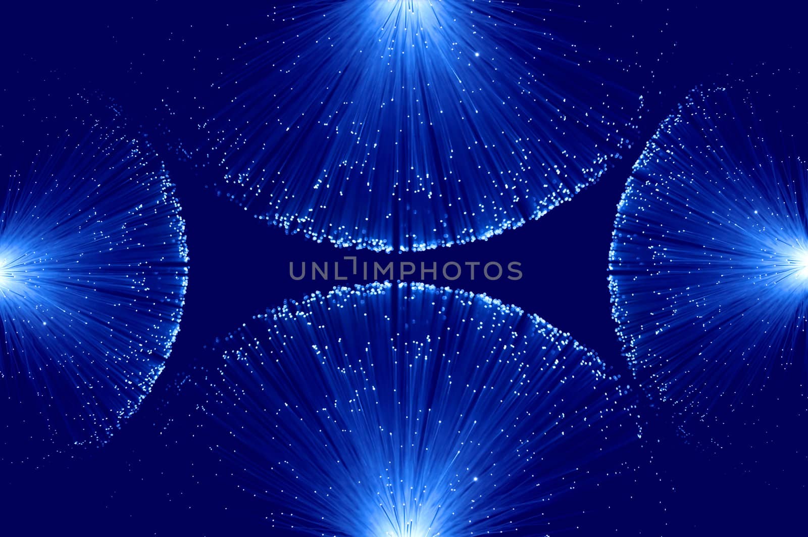 Four groups of illuminated blue fibre optic light strands eminating from each edge of the image against a blue background.