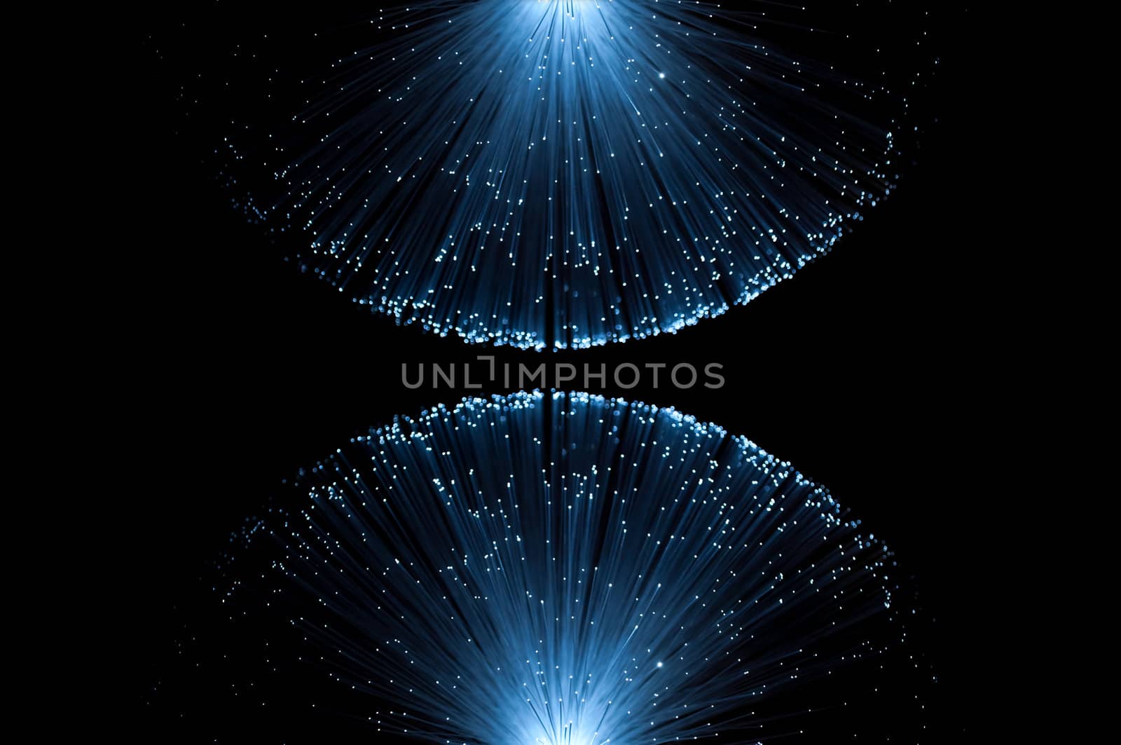 Two groups of illuminated blue fibre optic light strands eminating from the top and bottom border of the image against a black background.