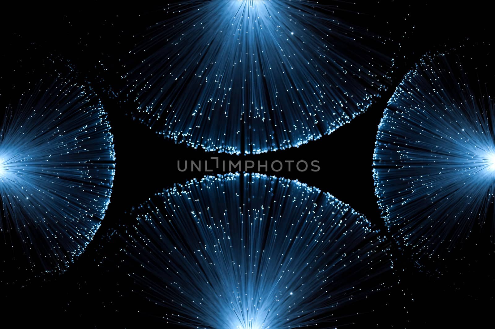 Four groups of illuminated blue fibre optic light strands eminating from each edge of the image against a black background.