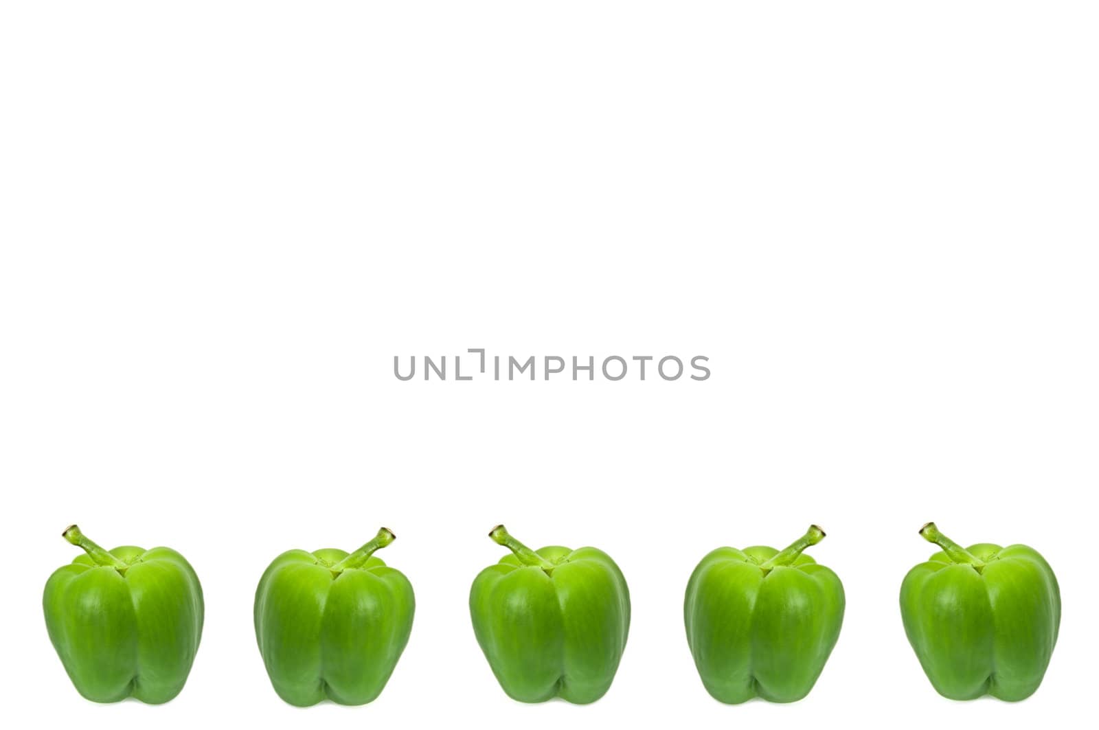 Five small whole green peppers arranged horizontally along the bottom border of the image over white.