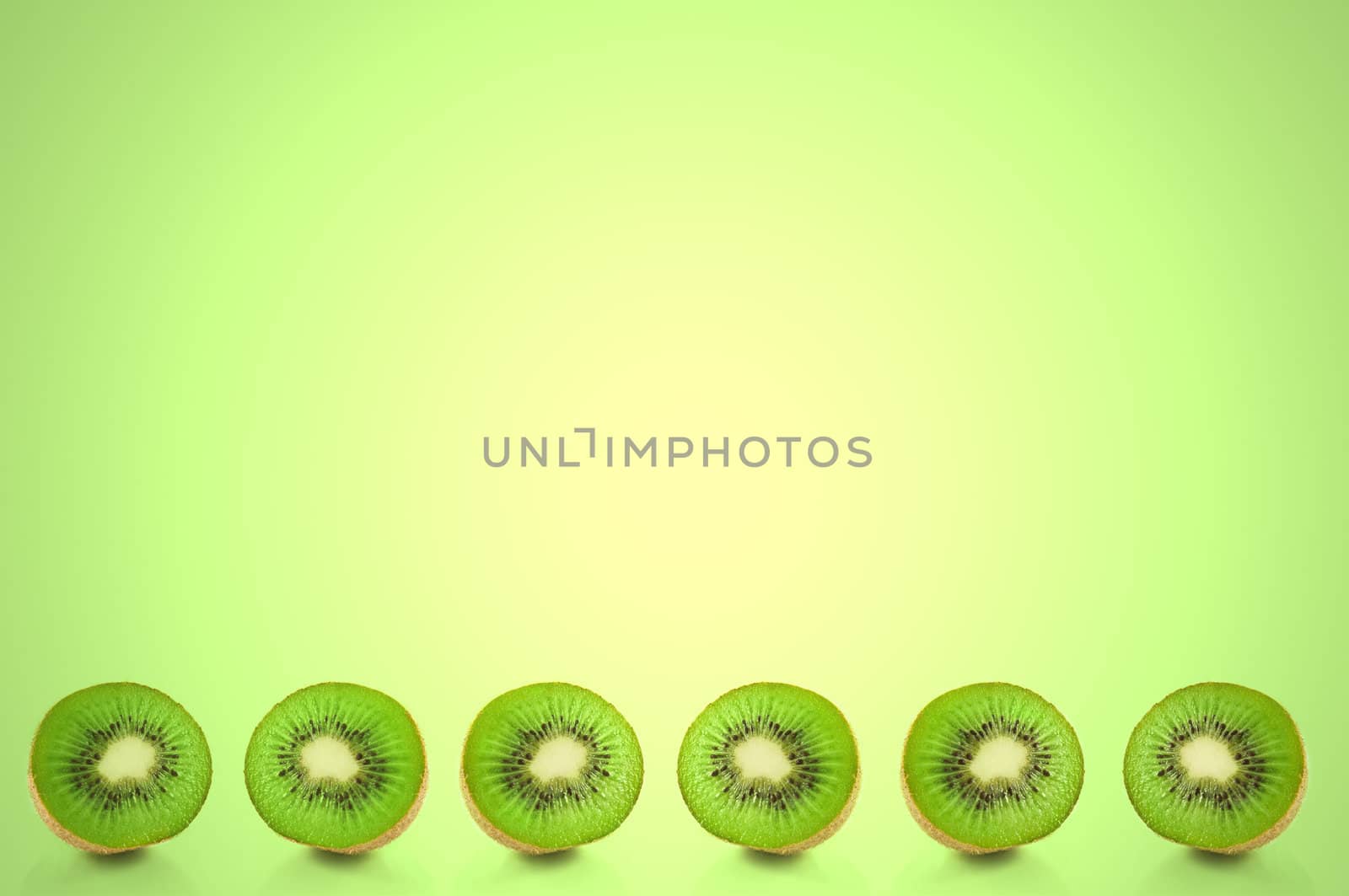 Six small kiwi fruit halves arranged in a horizontal line along the bottom of the image with green light effect filter background