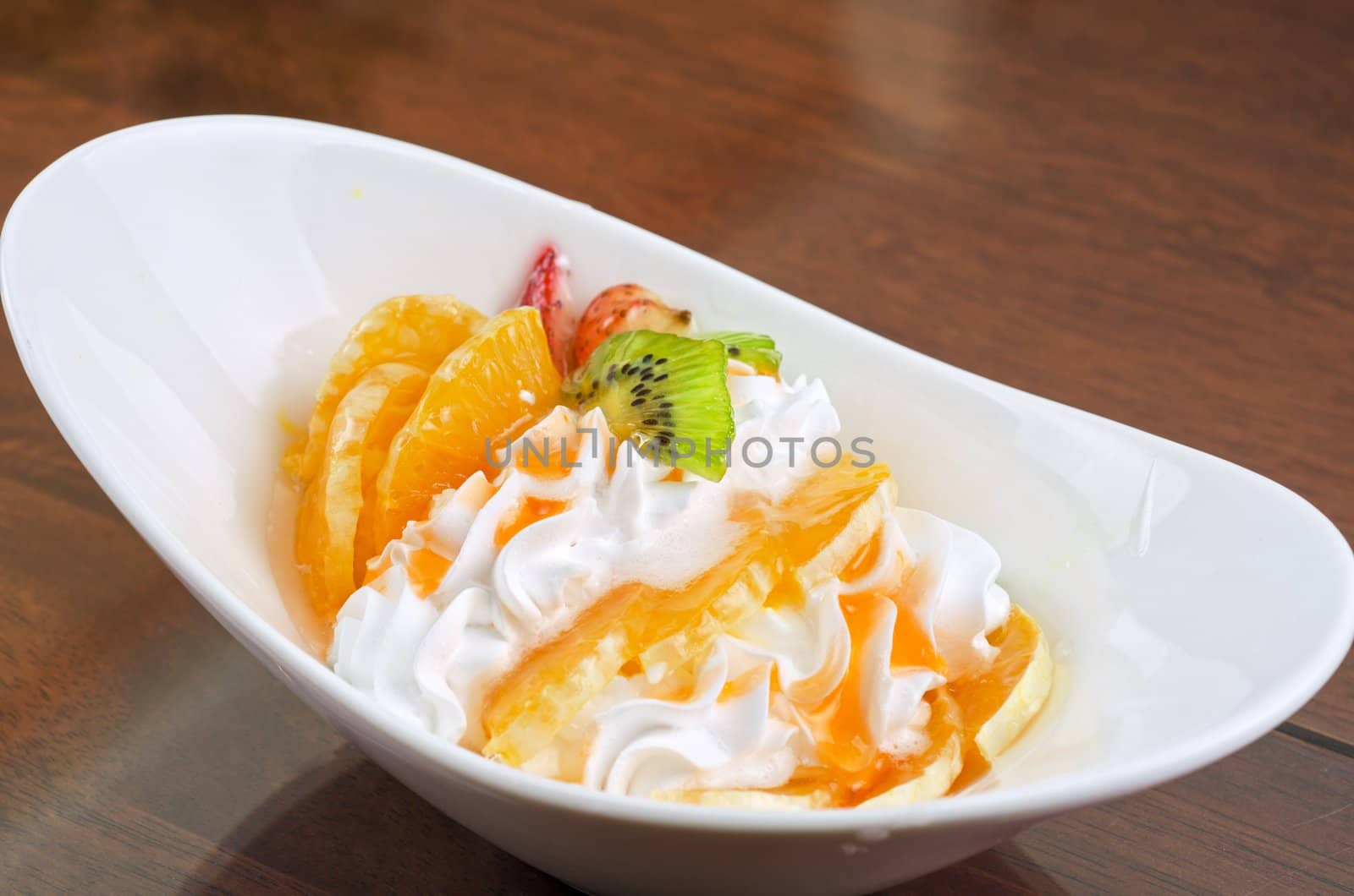 Ice cream dessert with kiwi, strawberry and orange