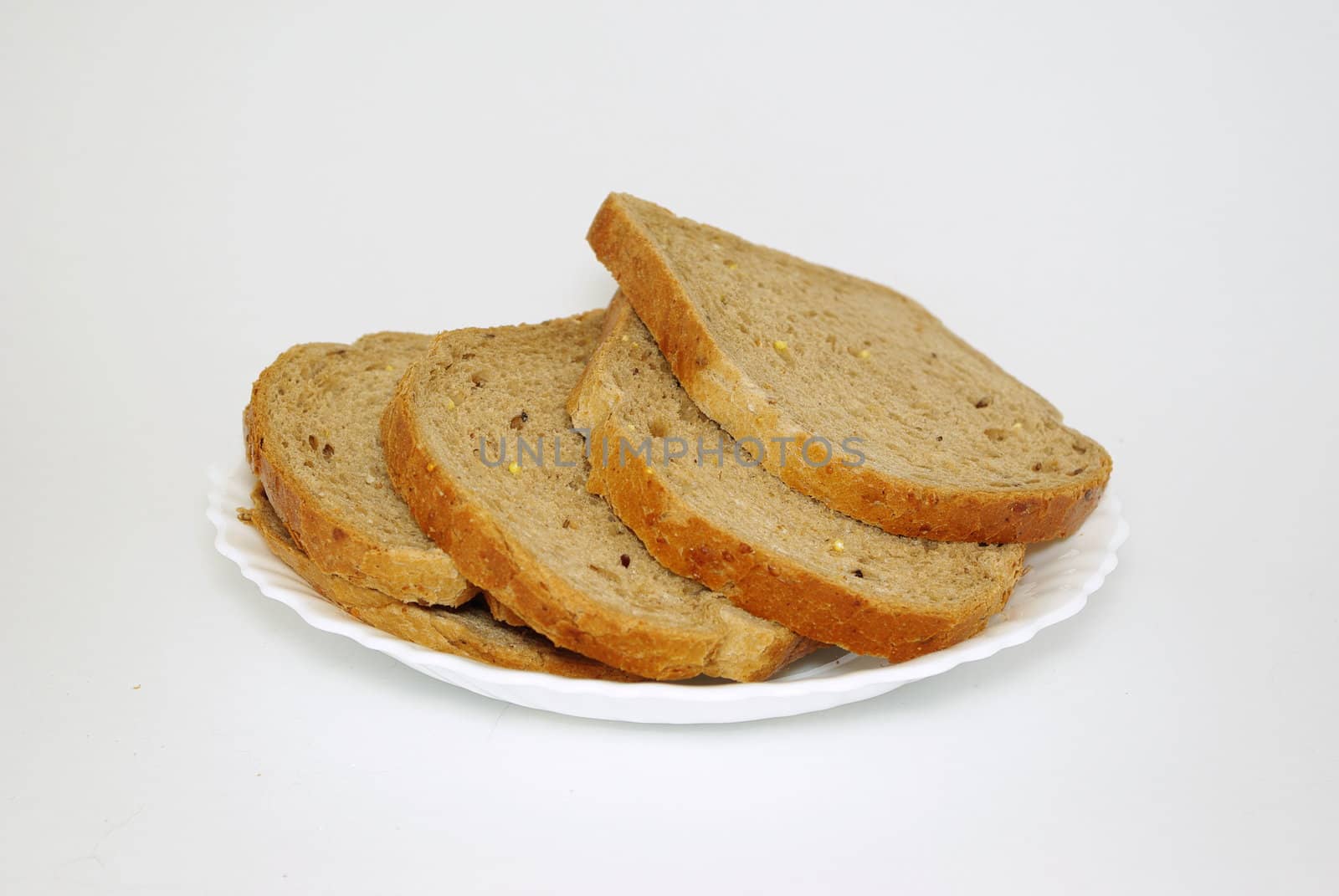 Pieces of bread on white plate