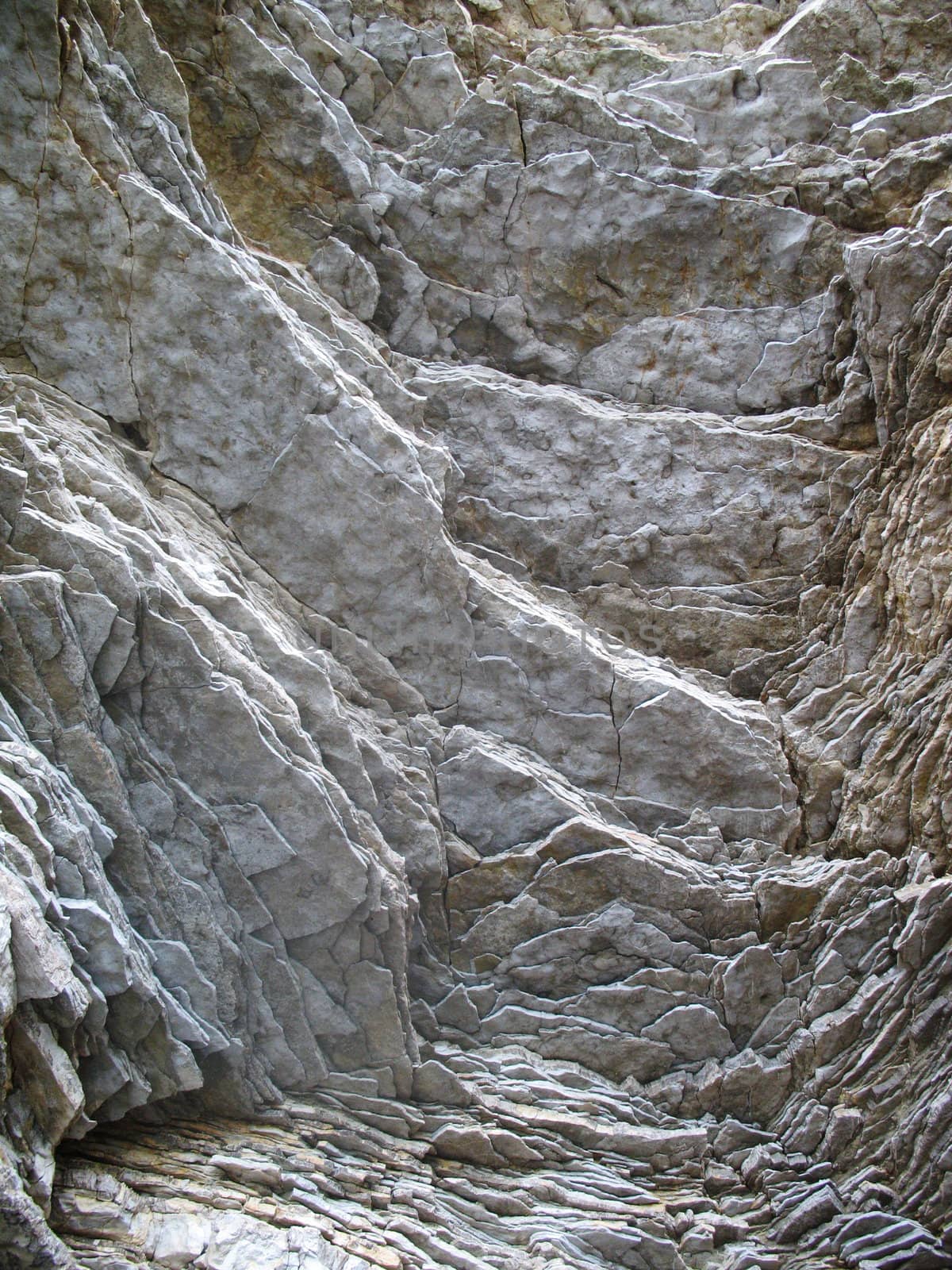Layered rock on high steep sea bank