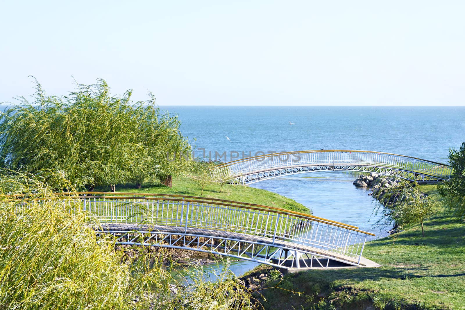 Pedestrian bridges across the river which flows into the sea