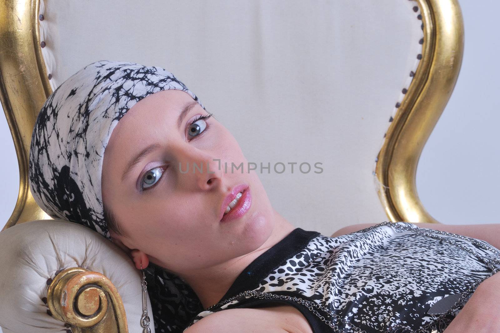Attractive woman lying back on chair