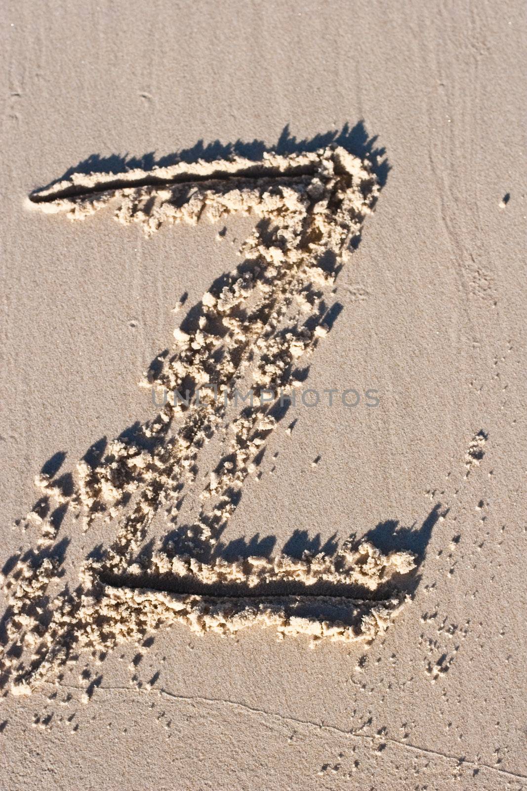 Letter Z drawn in the sand.