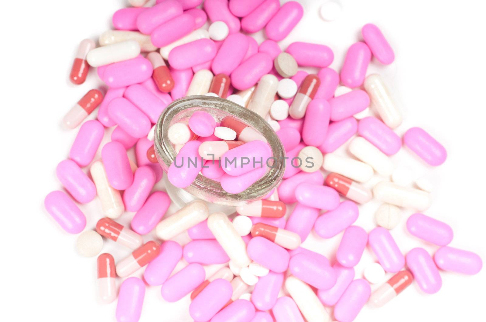 Shot of pink drugs (tablets) isolated on white