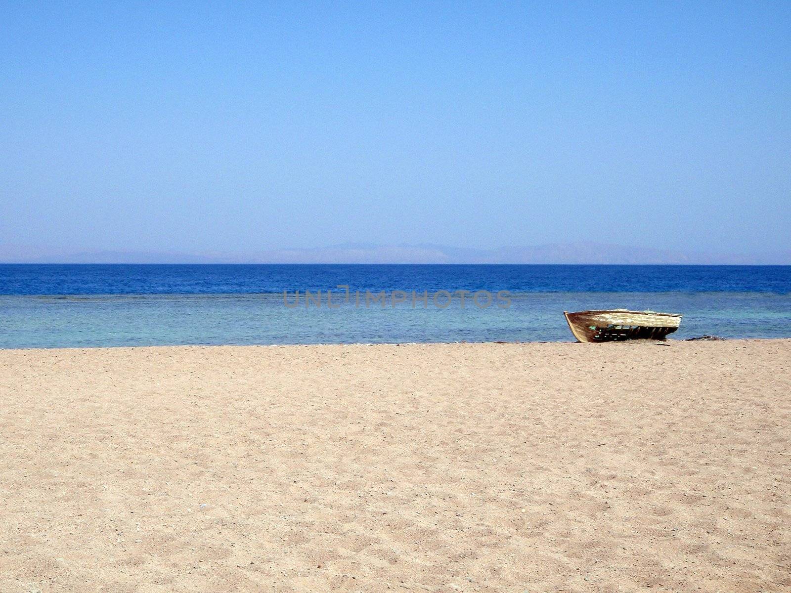 Lonely boat on sea coast by georg777