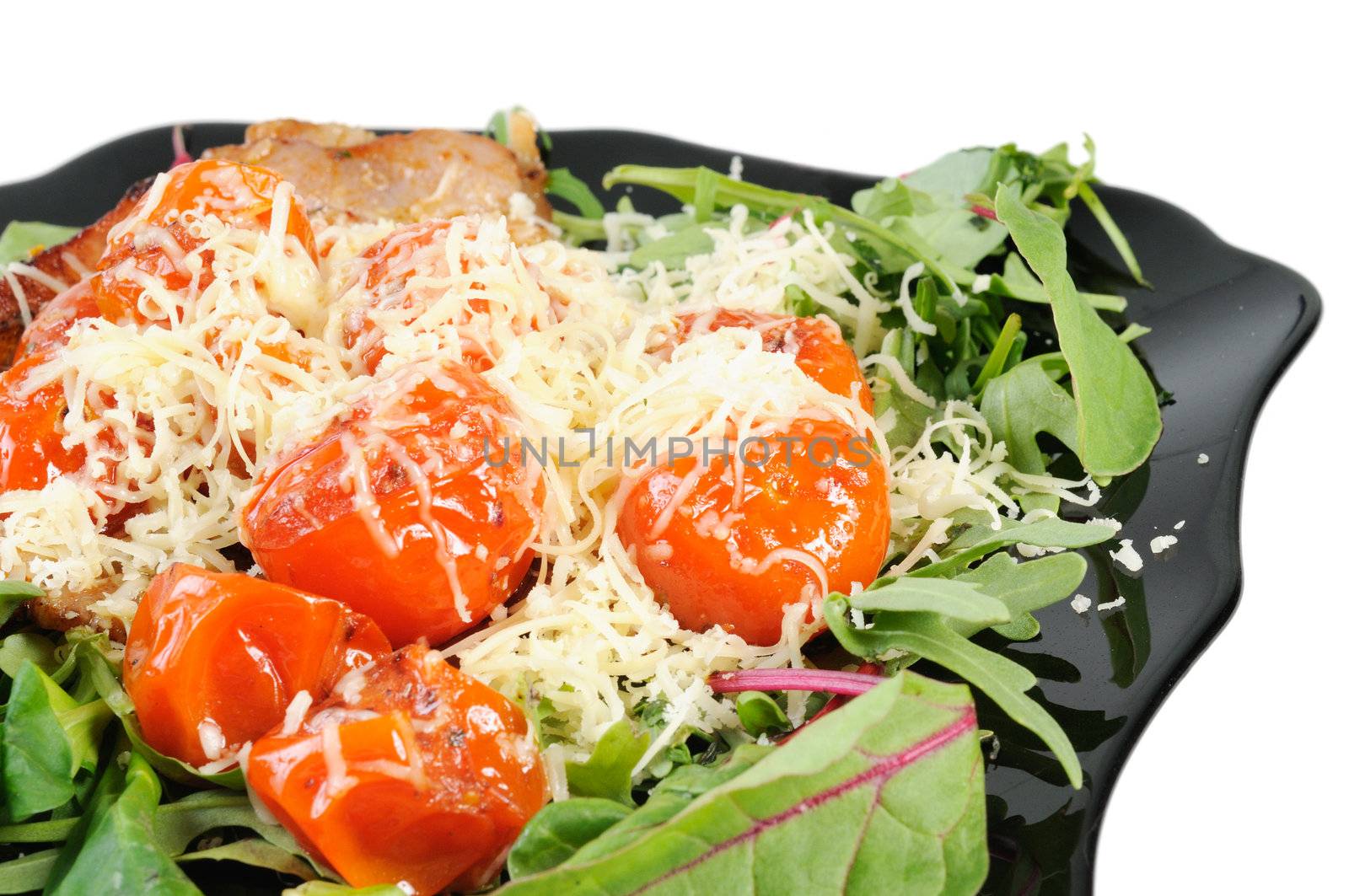 Salad with arugula and tomatoes. Isolated on white.