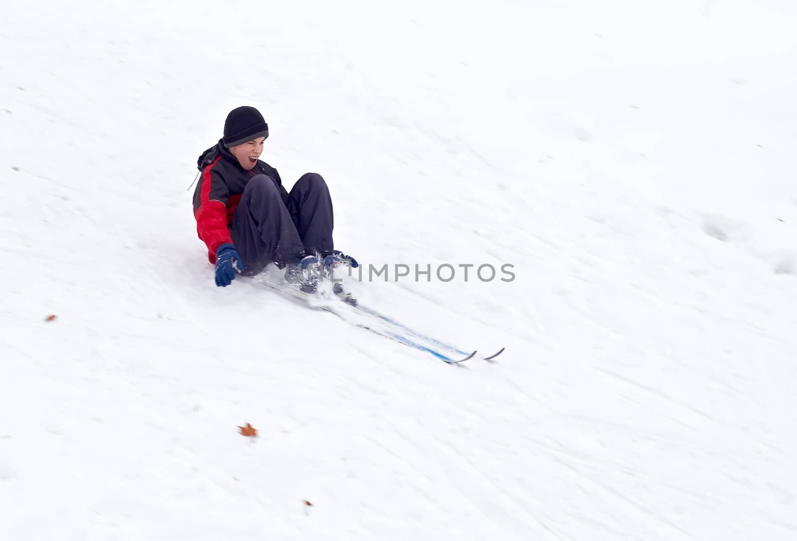 Cross country skier down the hill sitting