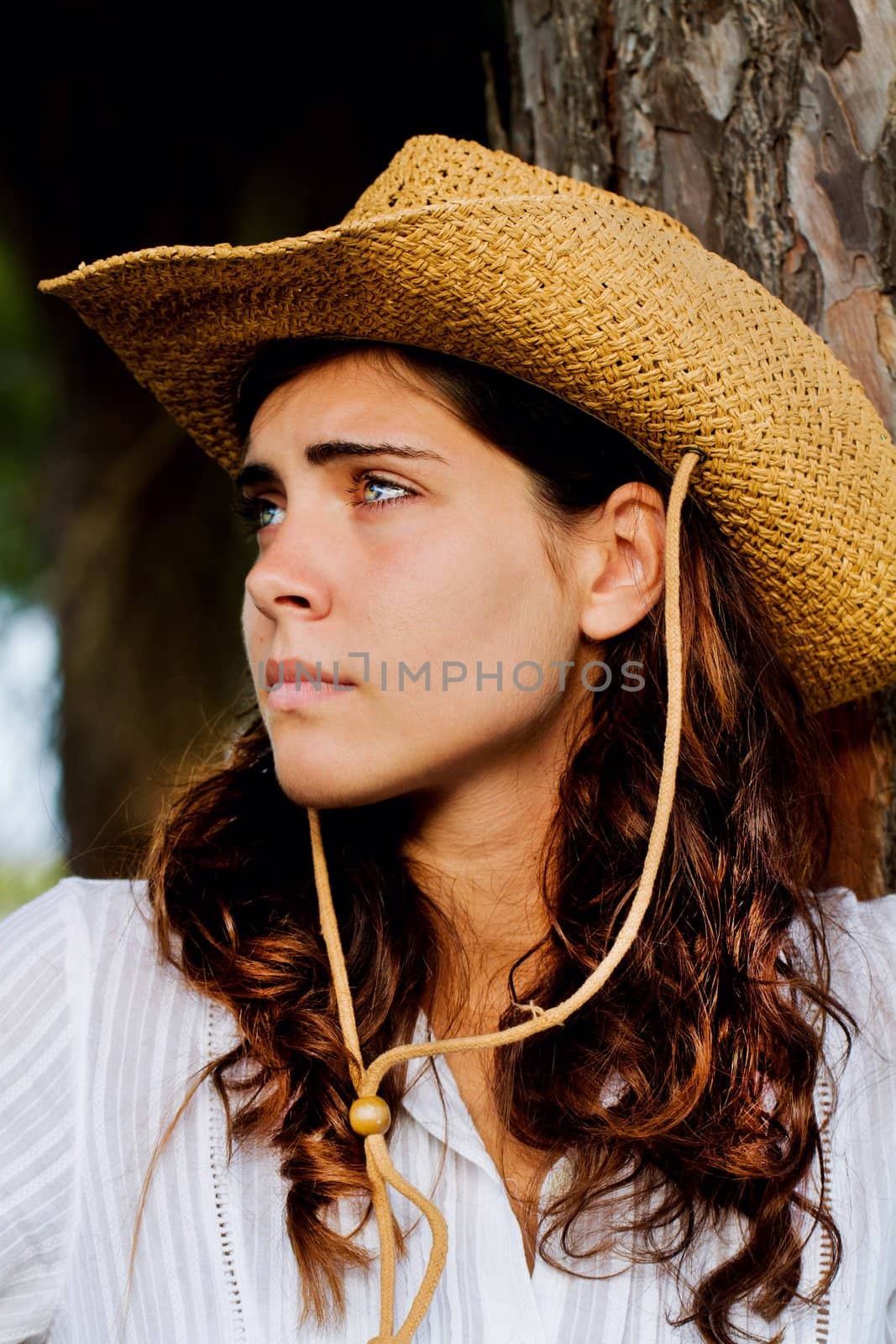 View of a beautiful young country girl with a guitar on the woods. 