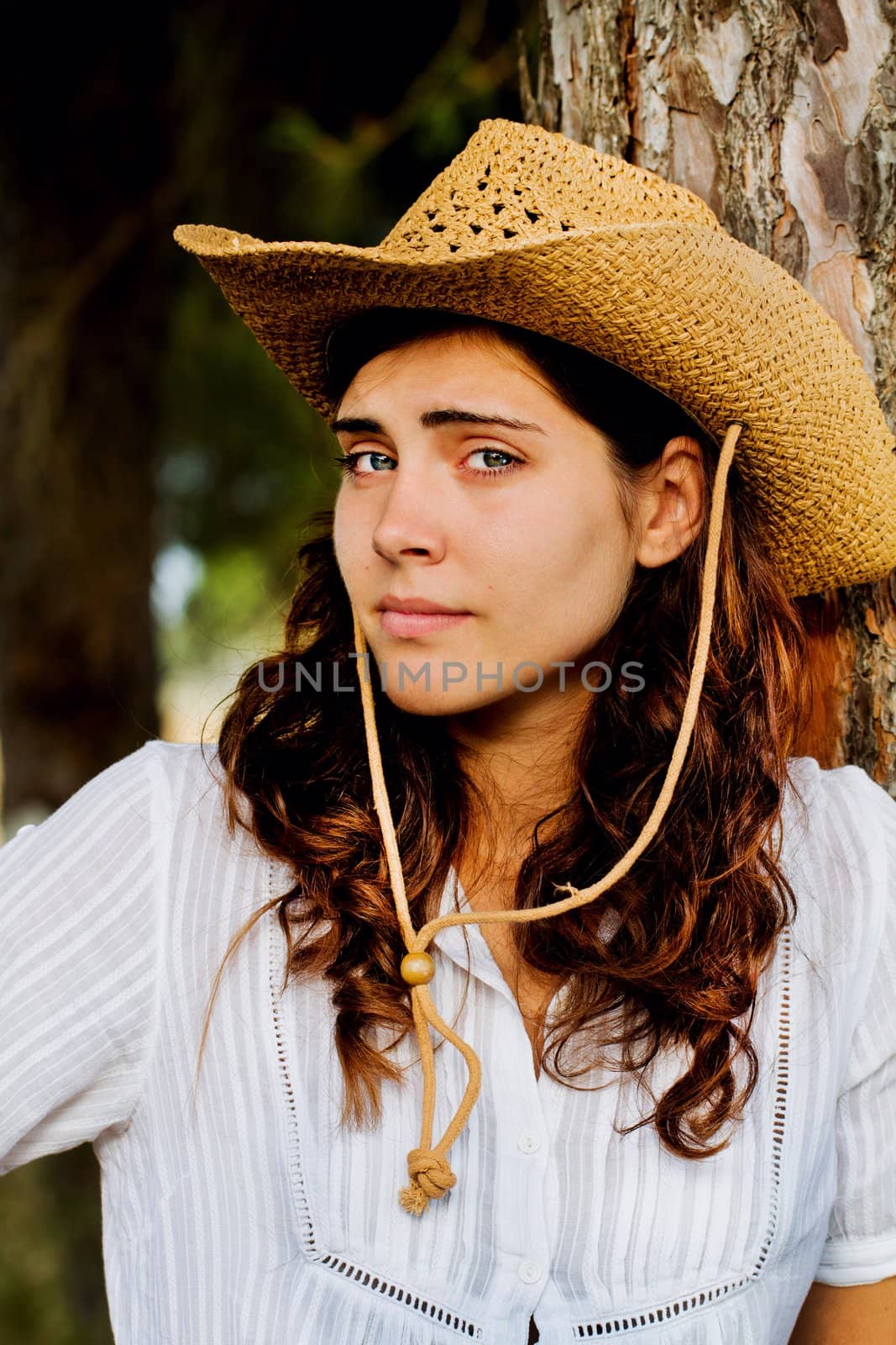 View of a beautiful young country girl with a guitar on the woods. 