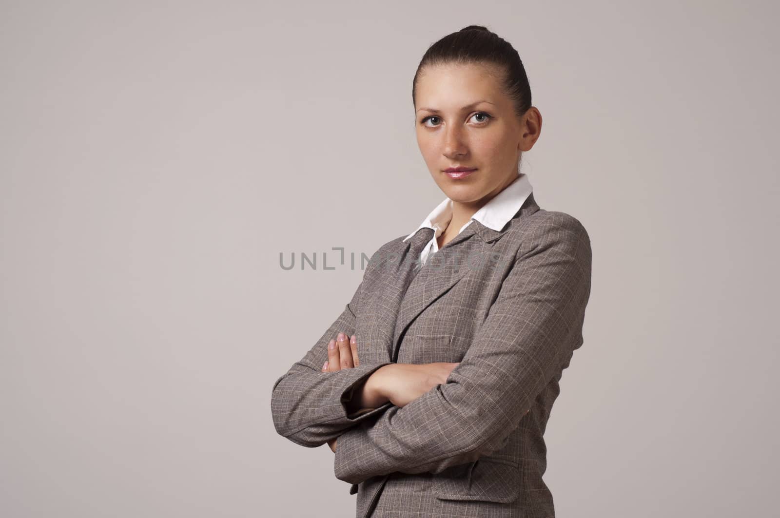 Portrait of a happy young business woman, fold one's arms