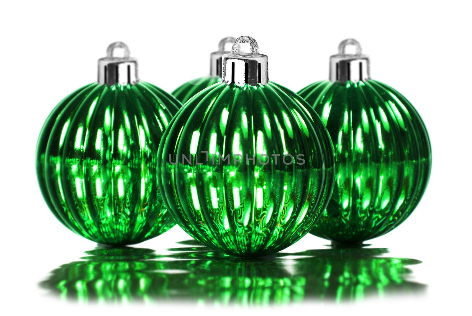 Green christmas decoration baubles on a white background with space for text