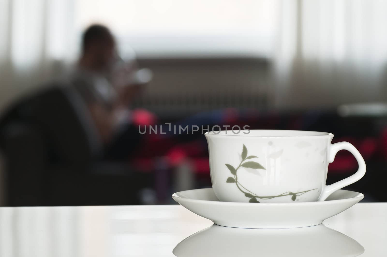 tea cup for relax time with blurred person in background