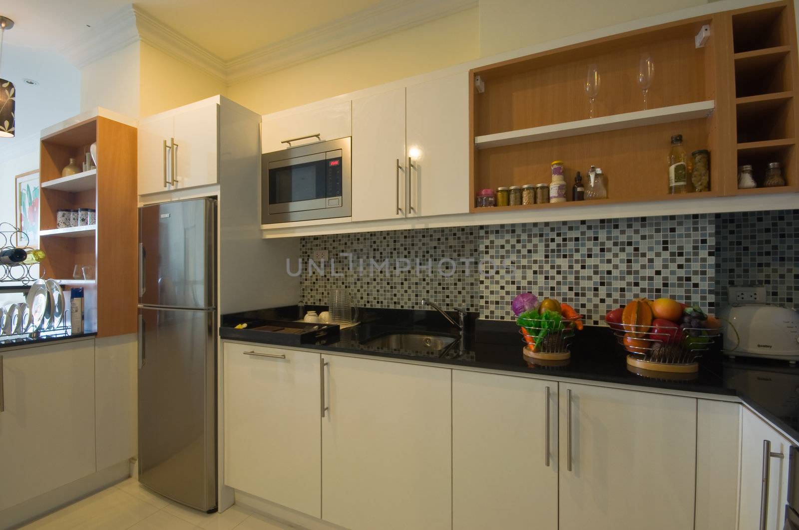 this picture is a white big kitchen in condominium