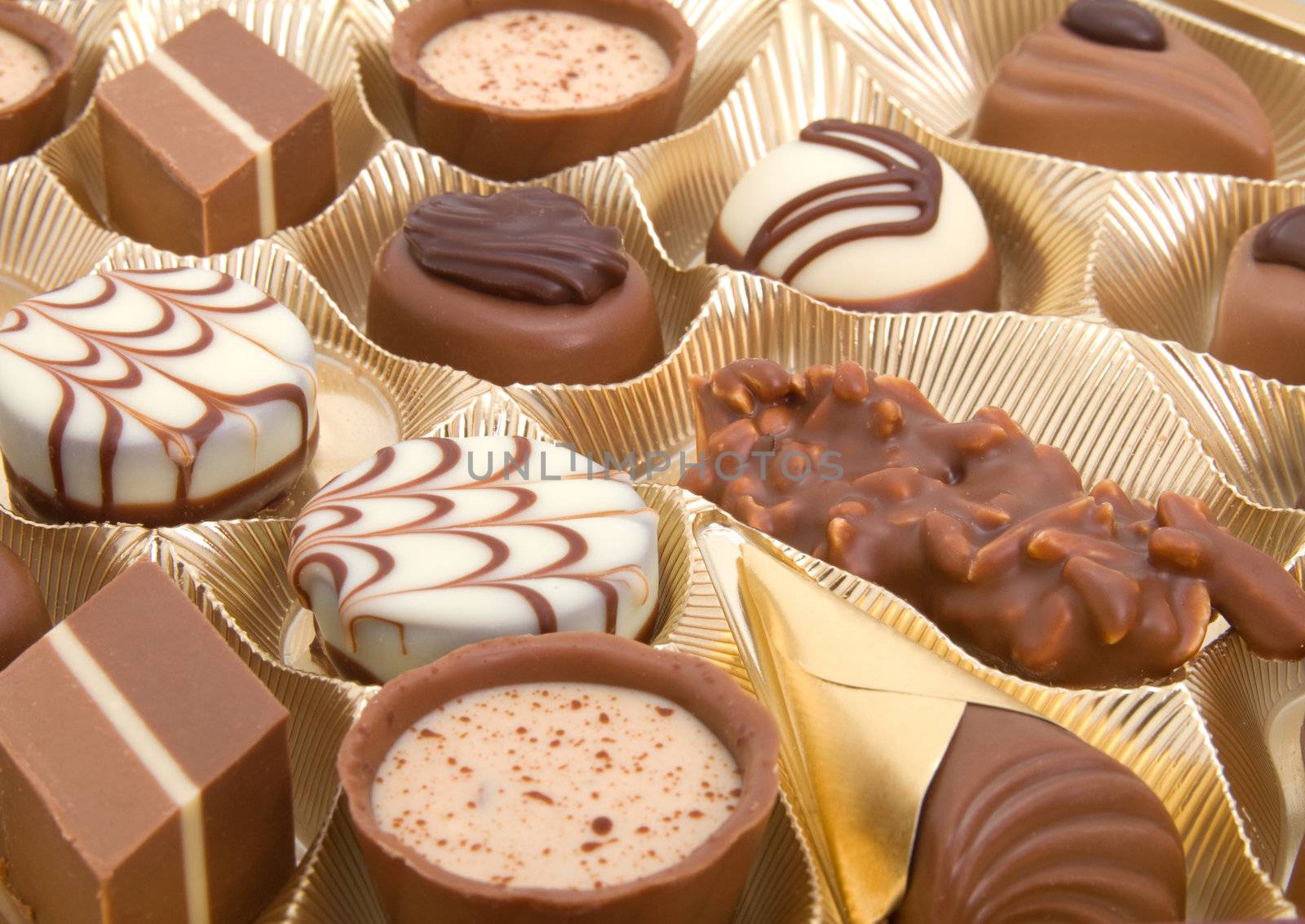 assortment chocolate pralines in a golden box