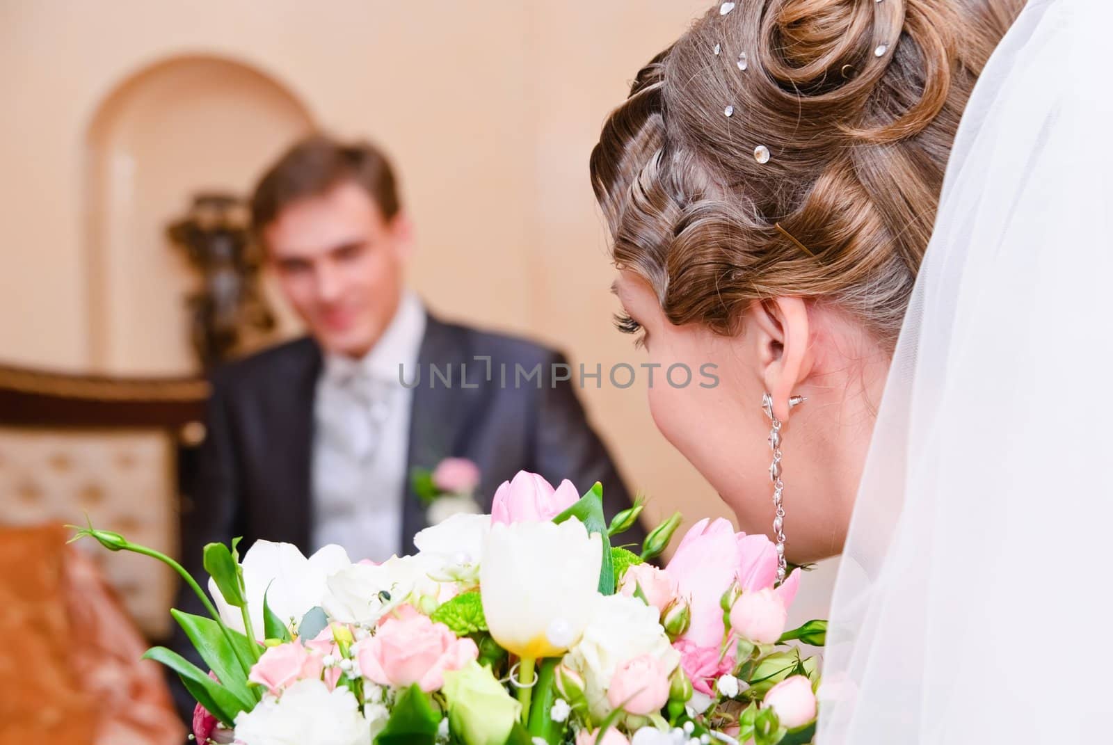 bridal bouquet of white roses and newlyweds