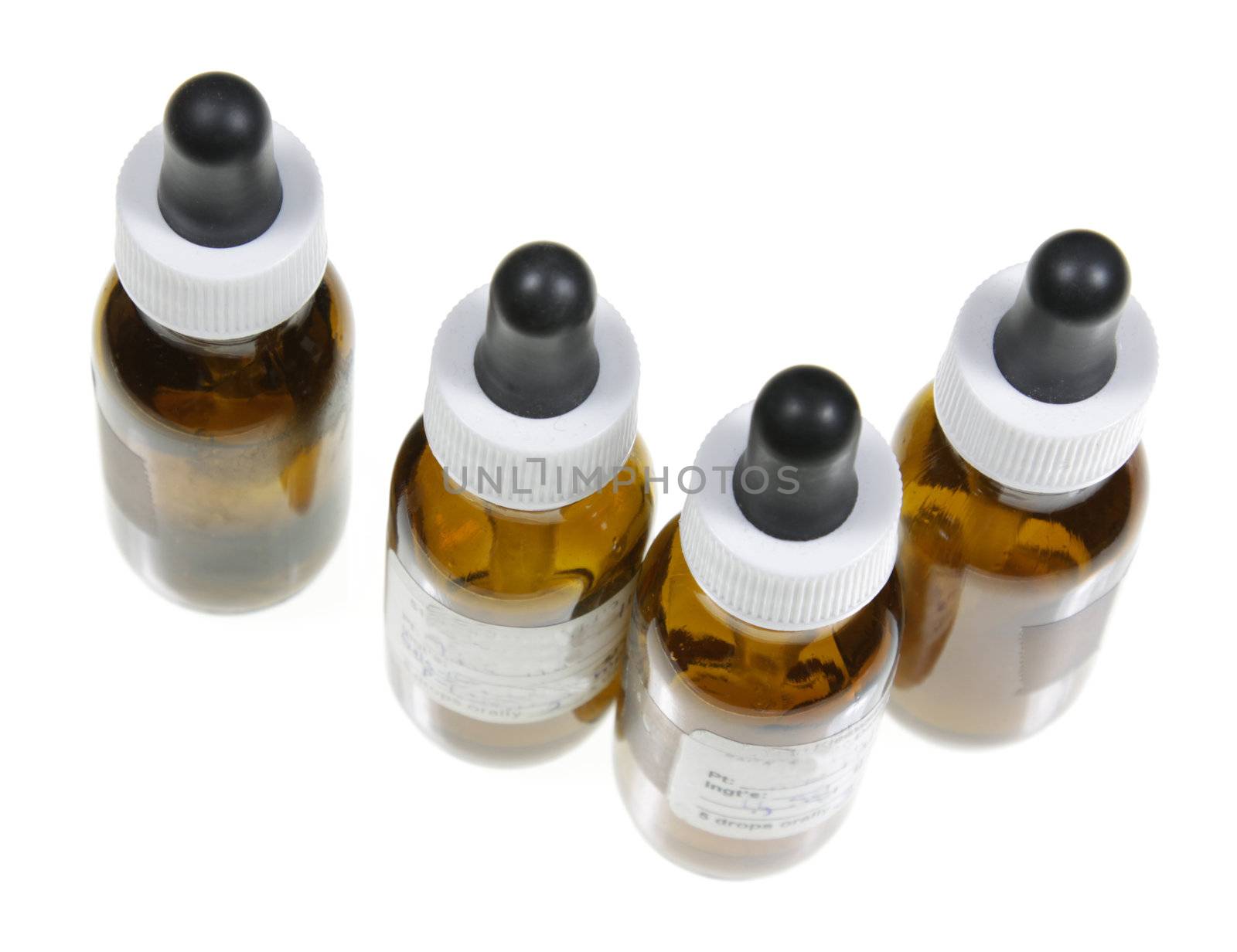 Four dropper bottles with naturopathic medicine in them.