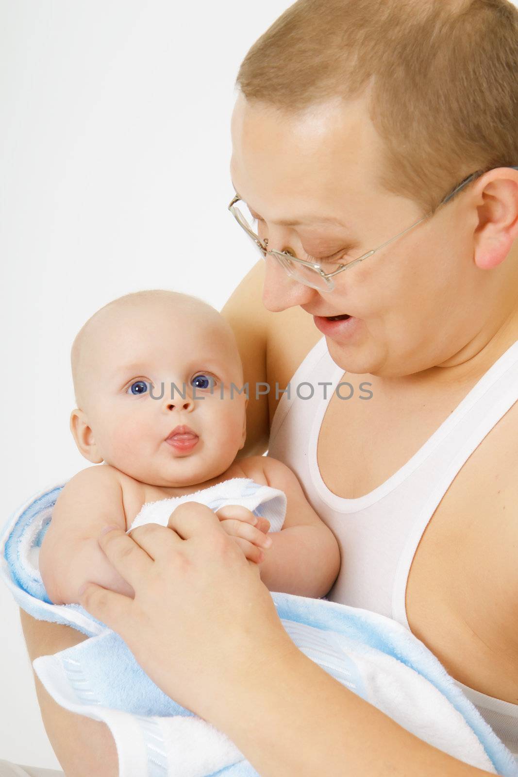 father is holding the baby. Studio photography
