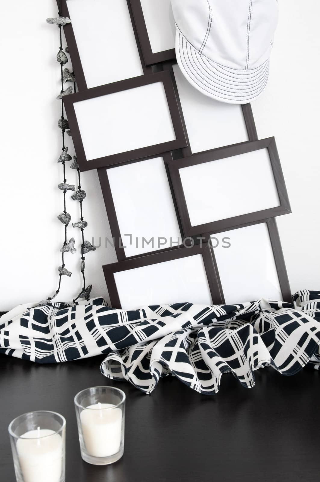 Black and white decor: photo frames, clothing and candles.