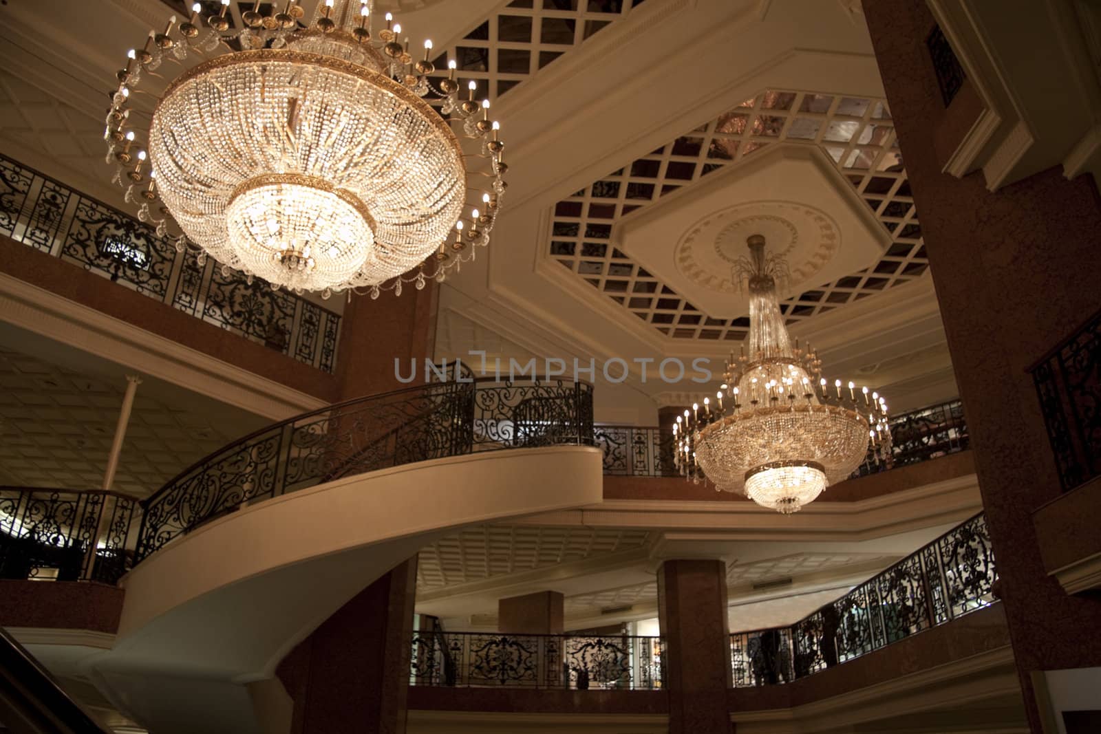A grand staircase and chandlers inside a mall in Monaco