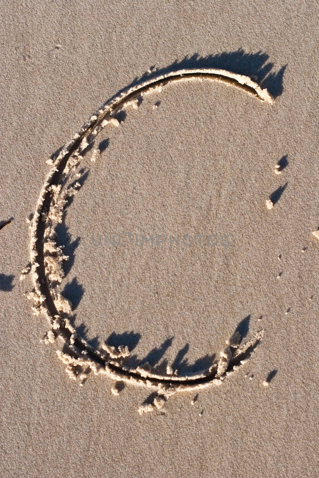 Letter C drawn in the Sand