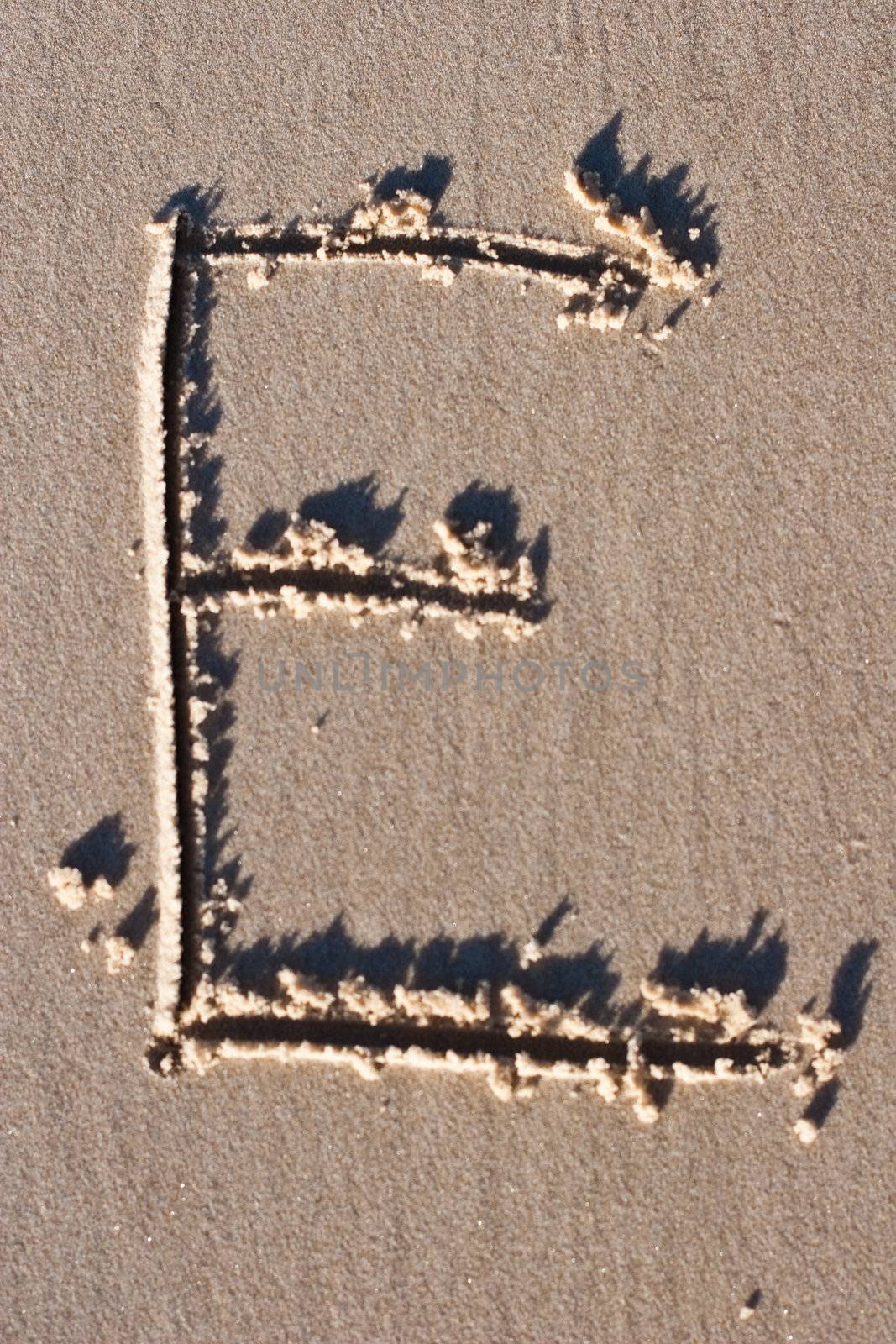 Letter E drawn in the Sand