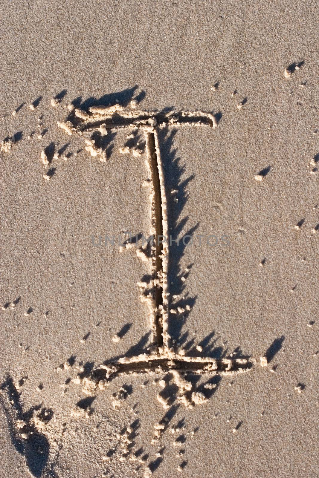 Letter I drawn in the sand. 