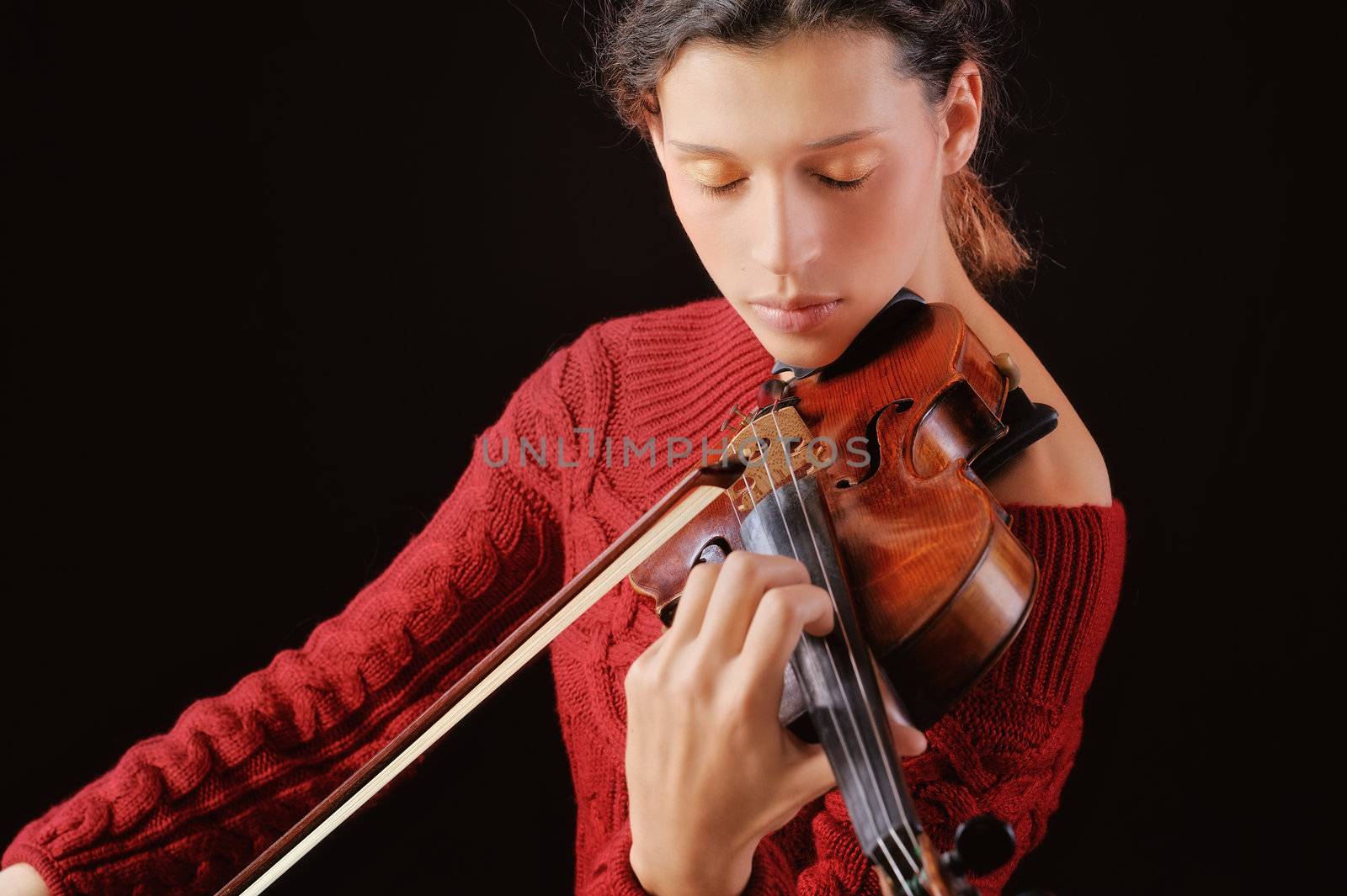 A young woman playing a violin with expression