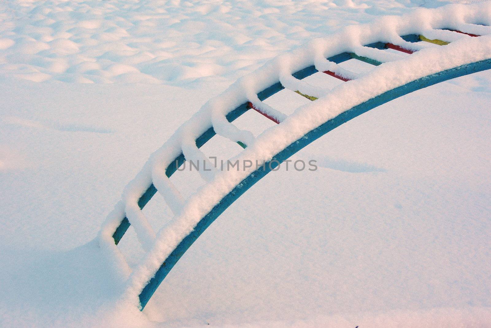 Playground in winter morning covered with snow