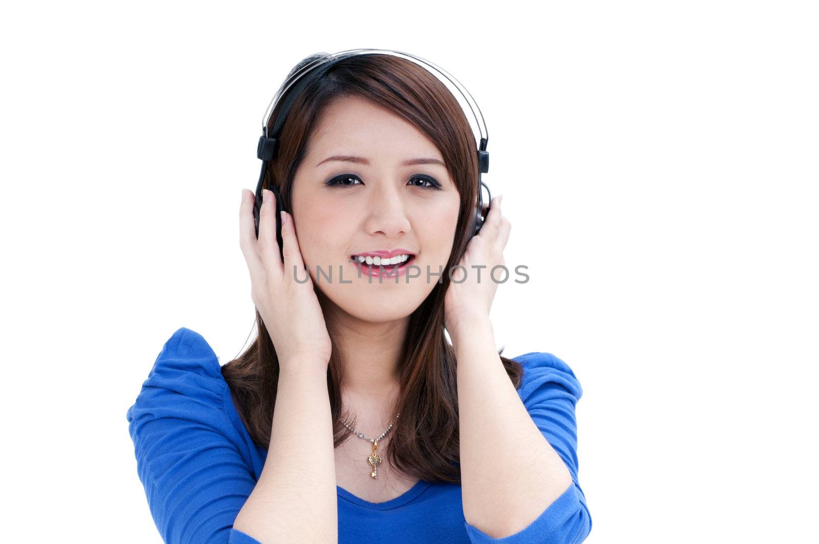 Portrait of an attractive young woman listening to music over white background.