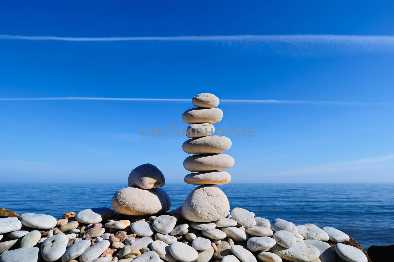 Balancing of white pebbles on the sea coast