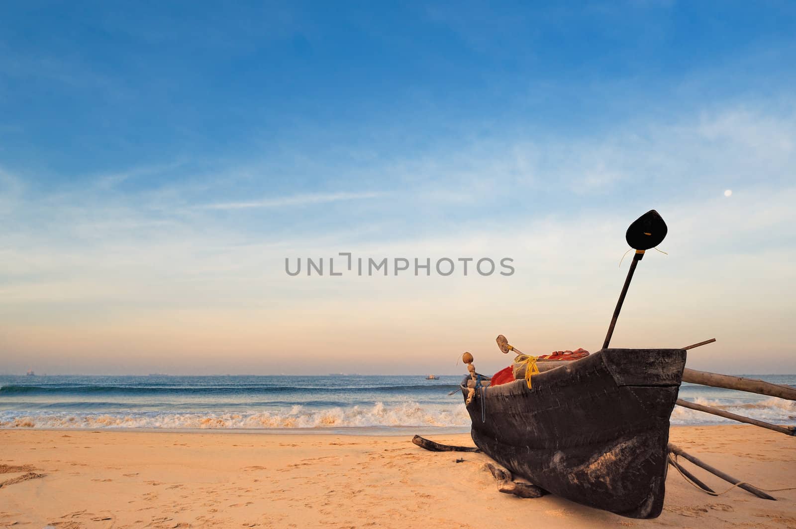 The old fishing boat on the sandy shore