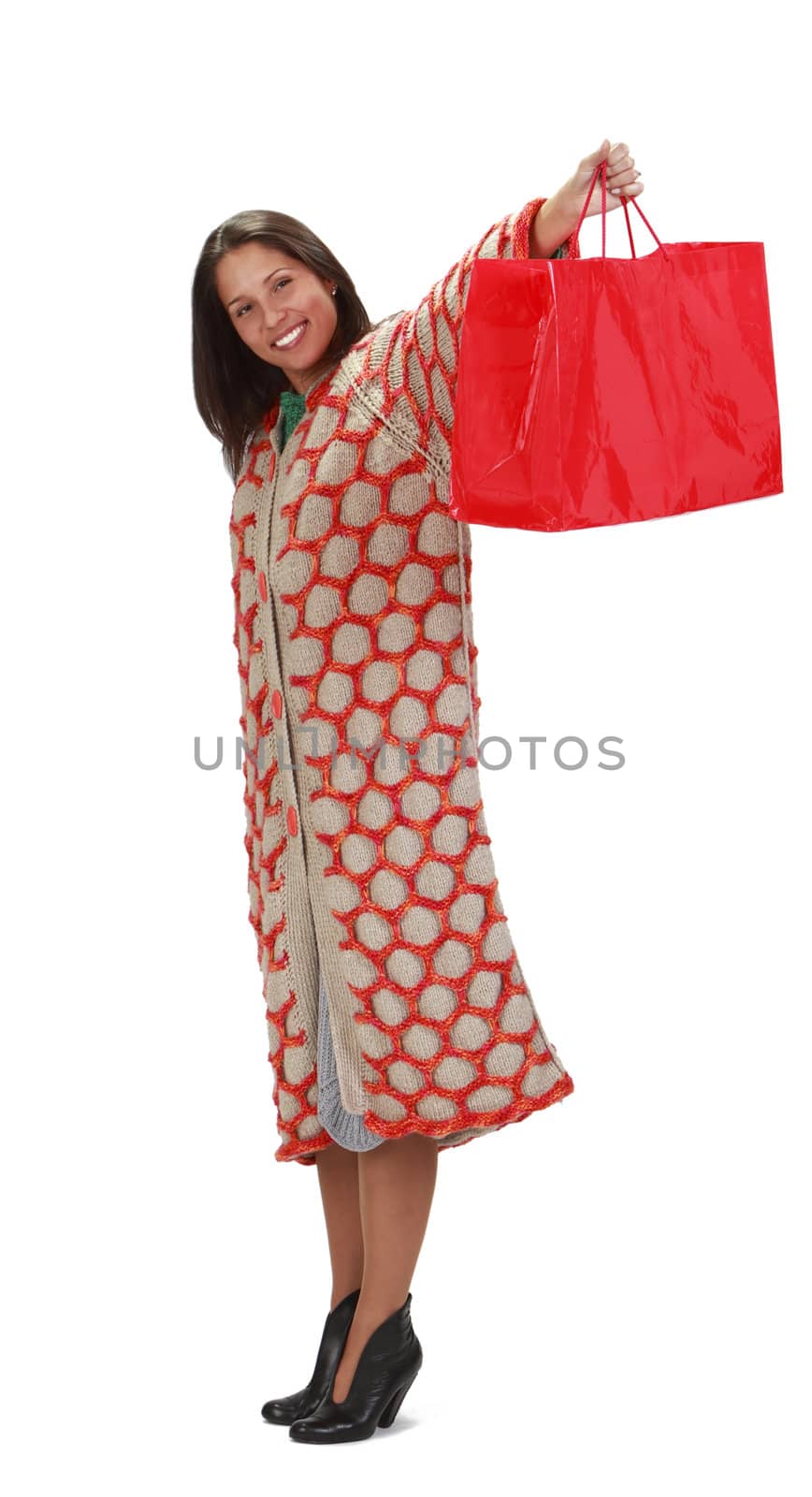 Happy young woman with a red shopping bag isolated against a white background.