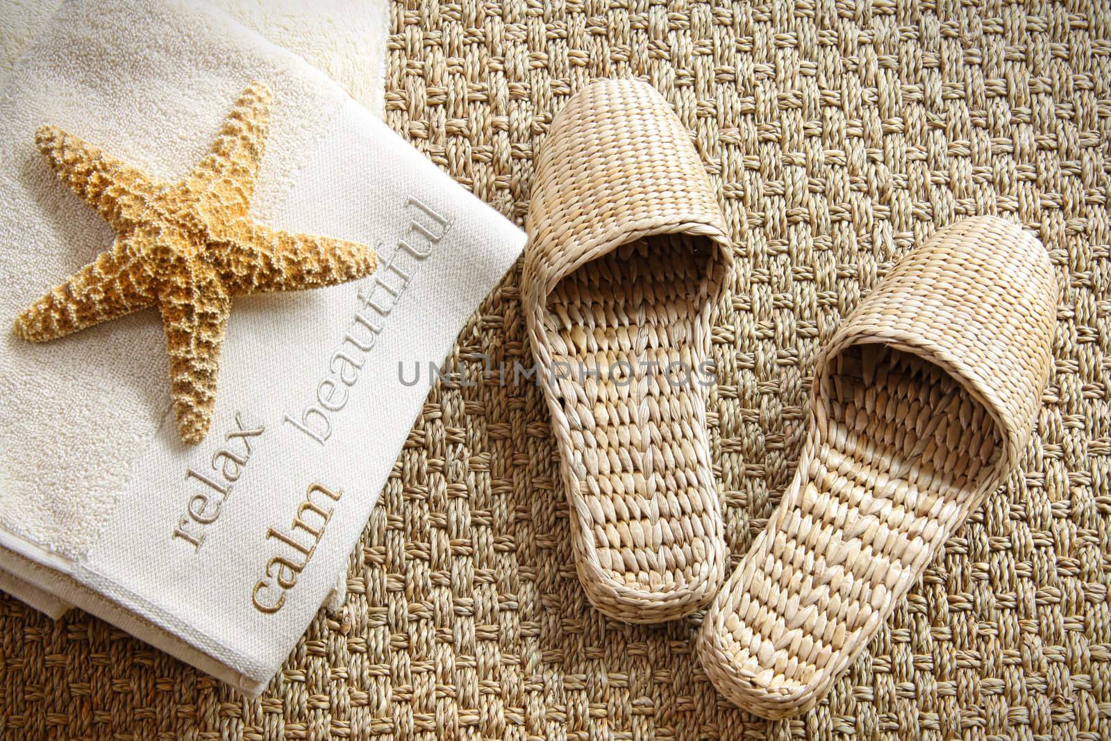 Spa slippers on seagrass carpet with towels  by Sandralise