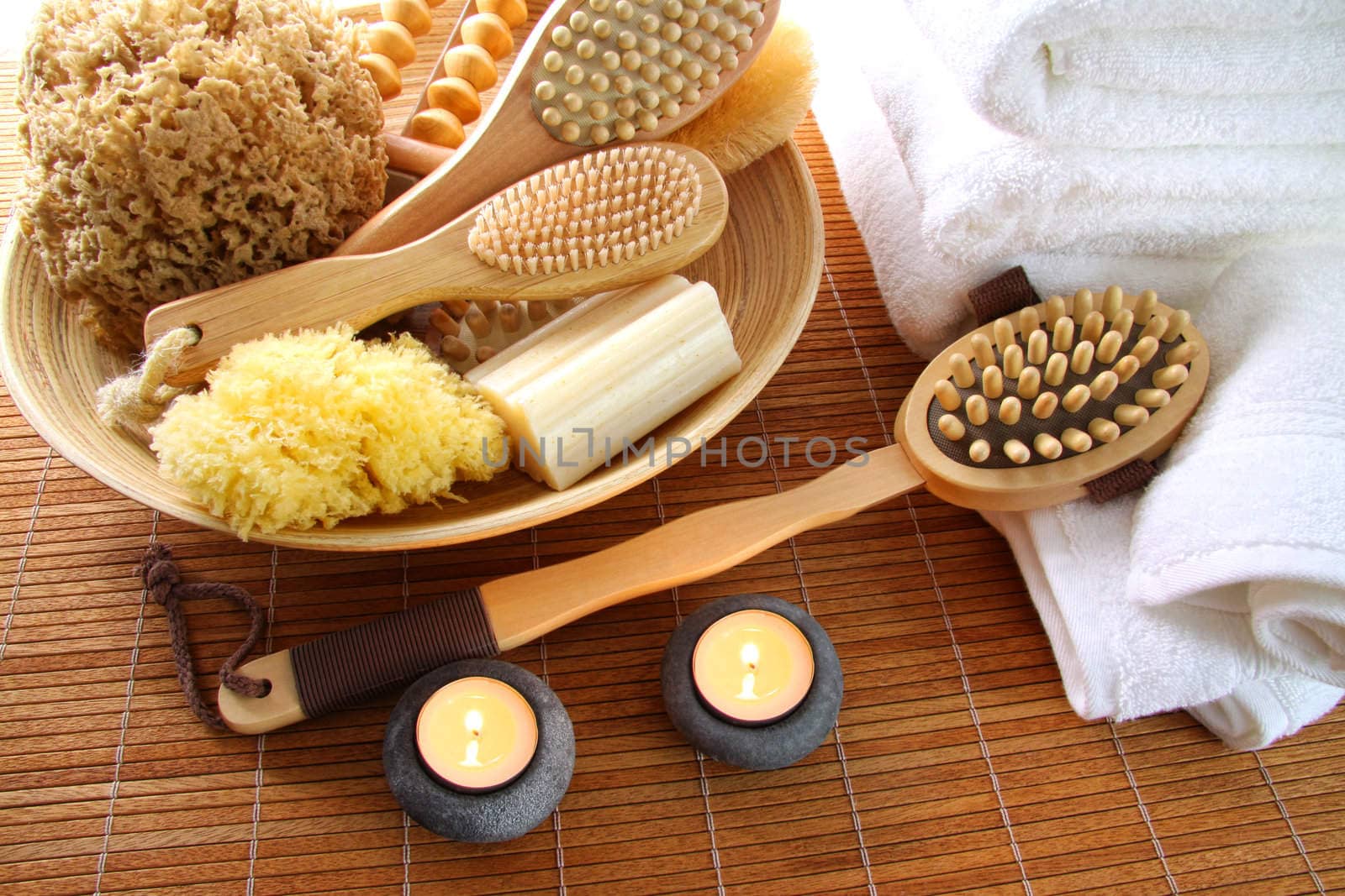 Spa brushes, sponges and soap on bamboo mat by Sandralise
