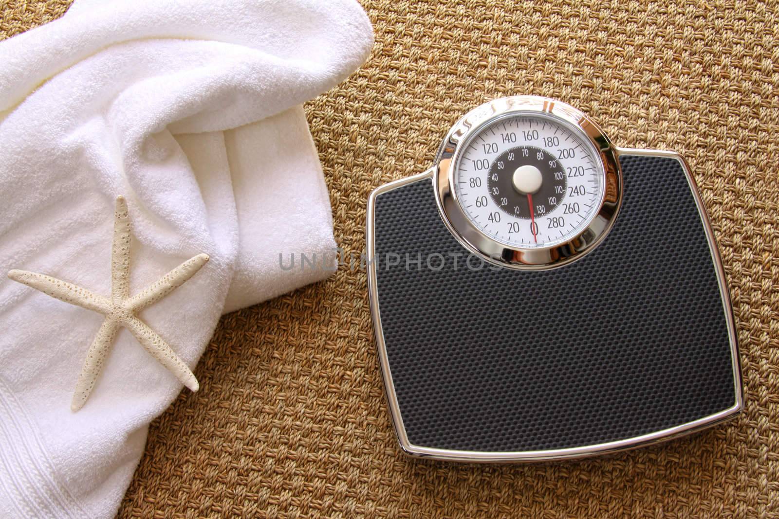 Weight scale with white towel on seagrass carpet